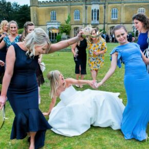 This bride certainly knew how to get into the party mode with her girlfriends as they walk through the gardens dancing every tipsy step of the way