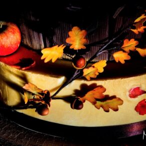 Striking autumnal cake dramatically lit to show every detail in this sugary masterpiece