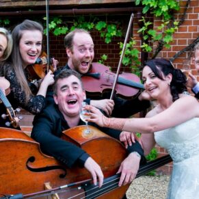 Even the musicians joined in for a fun pose at this lively wedding reception