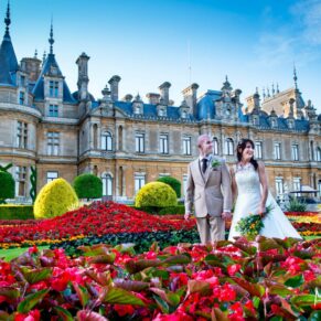 A visit to Waddesdon Manor for pictures with the bride and groom produced this striking image through the red flowers with the historic property completing the scene