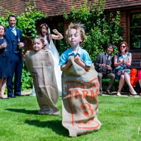 These kids staged a sack race at this lively wedding reception in the grounds of The Dairy - the bride and her guests are actively cheering them on in the background