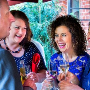 The guests enjoying the celebrations and the banter during the drinks reception on the terrace at The Dairy