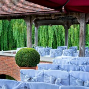 The Pavilion all setup for a glorious summer's day outdoor wedding ceremony over looking the lake at The Dairy