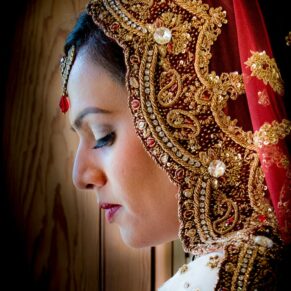 A dramatic portrait of an Asian bride captured in the West Hall before her wedding ceremony at The Dairy