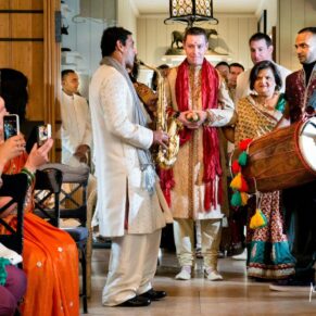 The groom's lively entrance to the West Hall for his Asian wedding ceremony at The Dairy
