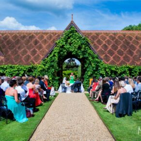 The outdoor ceremony in progress under perfect blue skies within The Dairy's stunning courtyard