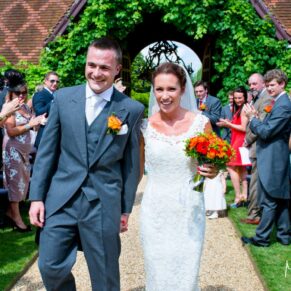 The newlyweds exit their outdoor courtyard ceremony to loud cheers at the Dairy