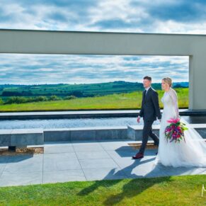 The smiling couple walking along at Windmill Hill with distant views on the Waddesdon Estate