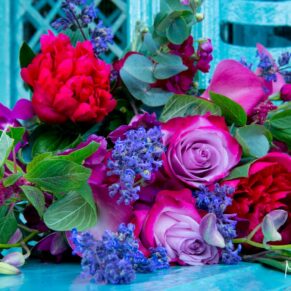 Strikingly colourful bouquet placed on the turquoise metalwork of the Aviary at Waddesdon Manor