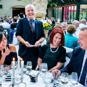 The magician performing his tricks around a table of appreciative and lively guests during the meal at The Dairy