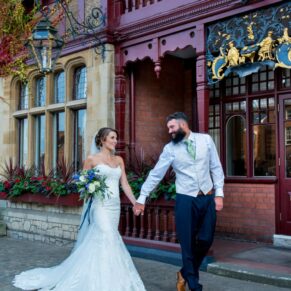 The newlyweds taking a stroll in front of their reception venue - The Five Arrows Hotel at Waddesdon