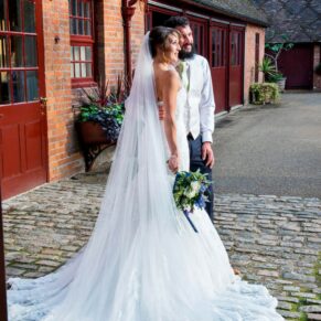 Five Arrows Waddesdon wedding photography of the newlyweds posing for a photo on the cobbles
