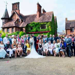 Large family wedding group pose captured on a summer's day at The Five Arrows Hotel in Waddesdon