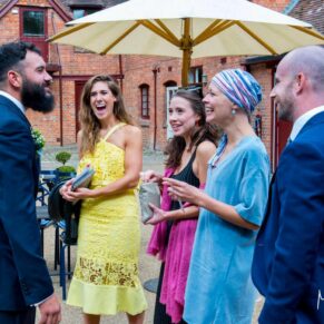 Five Arrows Hotel reportage capture of the groom and some guests in the venue's courtyard