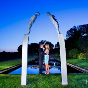 The newlyweds captured at dusk under the striking waterside sculptures at the Grove Hotel in Watford - some floodlighting has been added to create this wow result