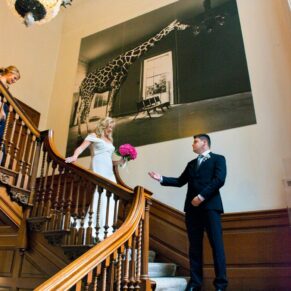 The bride is met by her son on the staircase before the ceremony