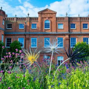 Striking exterior of The Grove Hotel on a hot sunny day