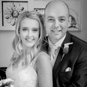The bride and groom posing for the camera with lovely soft window lighting at their Beaumont Estate wedding