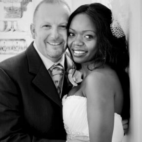 Black and white portrait of the happy newlyweds in the grand entrance area of the White House at their Beaumont Estate wedding
