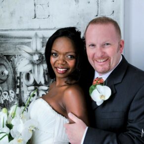 Portrait photography of the happy newlyweds lit through a big window in the White House at their summer Beaumont Estate wedding