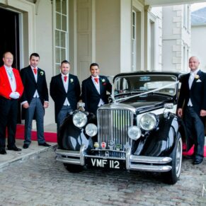 Wokefield Estate Berkshire Wedding Photography - the bridal party with the wedding car under the portico