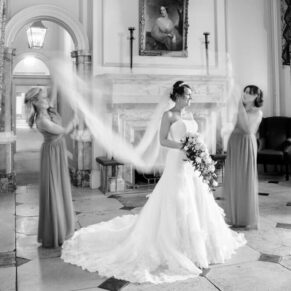 Wokefield Estate Berkshire Wedding Photography - dramatic black and white shot in the grand entrance of the bride with her bridesmaids