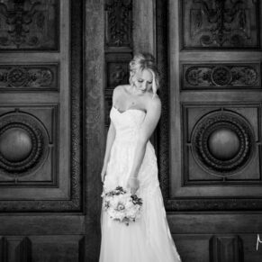 caption info Bride in front of carved wooden doors at Waddesdon Manor wedding