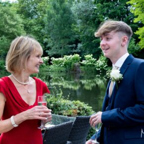 The bride captured chatting to her son during the drinks reception in the grounds of Saint Michael's Manor