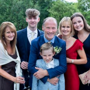 A relaxed group pose of the newlyweds with their children & relatives taken in the lovely gardens of Saint Michael's Manor