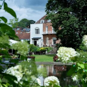 The historic Saint Michael's Manor viewed through the gorgeous flower gardens
