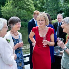 The happy bride relaxing beside the lake with some of her family at their Saint Michael's Manor wedding
