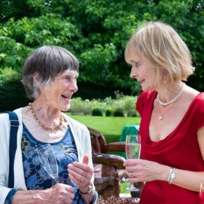 The bride chatting with a relative during the outdoor drinks reception