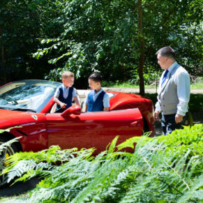 Lads with their Ferrari captured through the ferns at this stunning woodland marriage