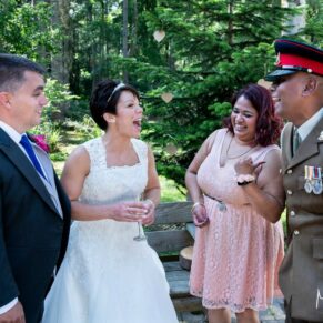 Candid wedding image capturing lots of laughter at this woodland drinks reception