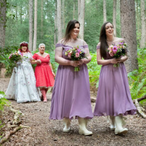 The bride and her entourage arriving at the dell through the woodland route to the civil marriage ceremony