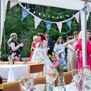 A wide view through the marquee towards the drinks reception at this summer celebration