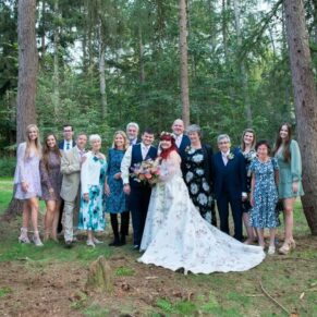 Larger family group pose captured amongst the woodlands majestic trees