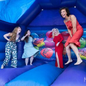 Guests jumping on the bouncy castle at this Mercure Lambert Hotel wedding, Thame