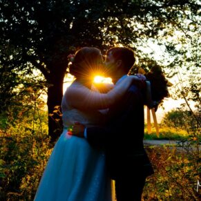 The bride and groom silhouetted at sunset at their Mercure Lambert Hotel wedding, Thame