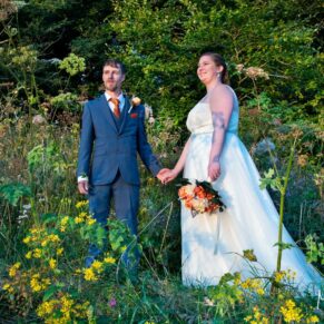 The bride and groom pose for a photo in a flower meadow at their Mercure Lambert Hotel wedding, Thame
