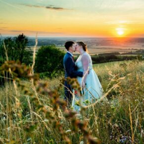 The newlyweds pose for a sunset shot at a local beauty spot on their wedding day at The Mercure Lambert Hotel, Thame