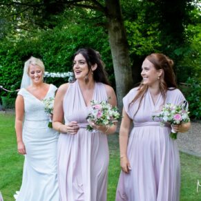 The bridesmaids take a stroll in the gardens, captured at The Grange, Northwood