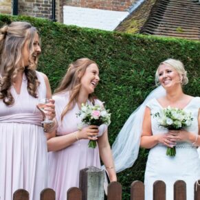 The bride relaxing with her bridesmaids captured at The Grange, Northwood wedding