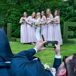 The groom goes for a low down angle of the bridesmaids with his camera, captured at The Grange, Northwood wedding