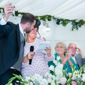 The groom kisses his mum during his wedding speech, captured at The Grange, Northwood