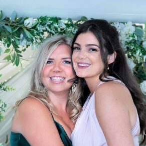 Two ladies enjoy a hug, captured at The Grange, Northwood wedding