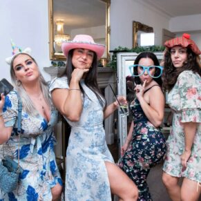 A fun shot captured of four wedding guests posing for the camera at The Grange, Northwood