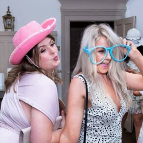Two ladies in their photo-booth outfits, captured at The Grange, Northwood wedding