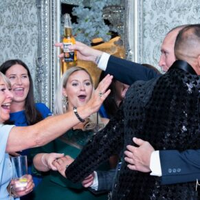Joyful hugs from the wedding guests captured at The Grange, Northwood