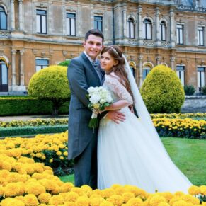 Bride & groom pose in the flower borders at Waddesdon Manor